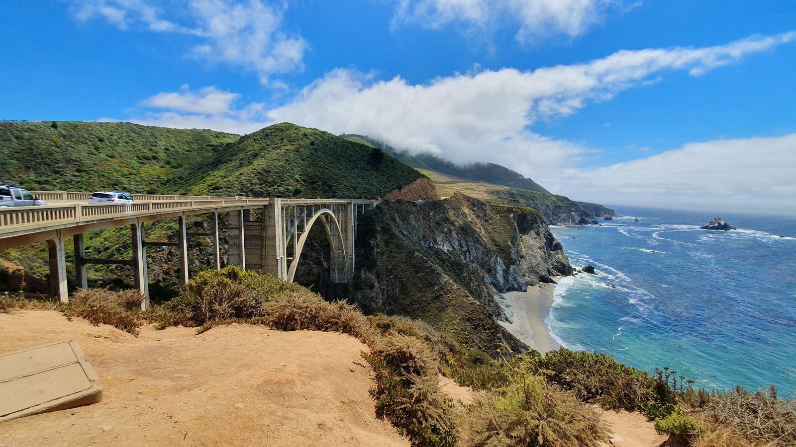 The Bixby Creek Bridge on Highway 1 in Big Sur, with cliffs and blue sea, high on any list of things to do in Northern California coast country